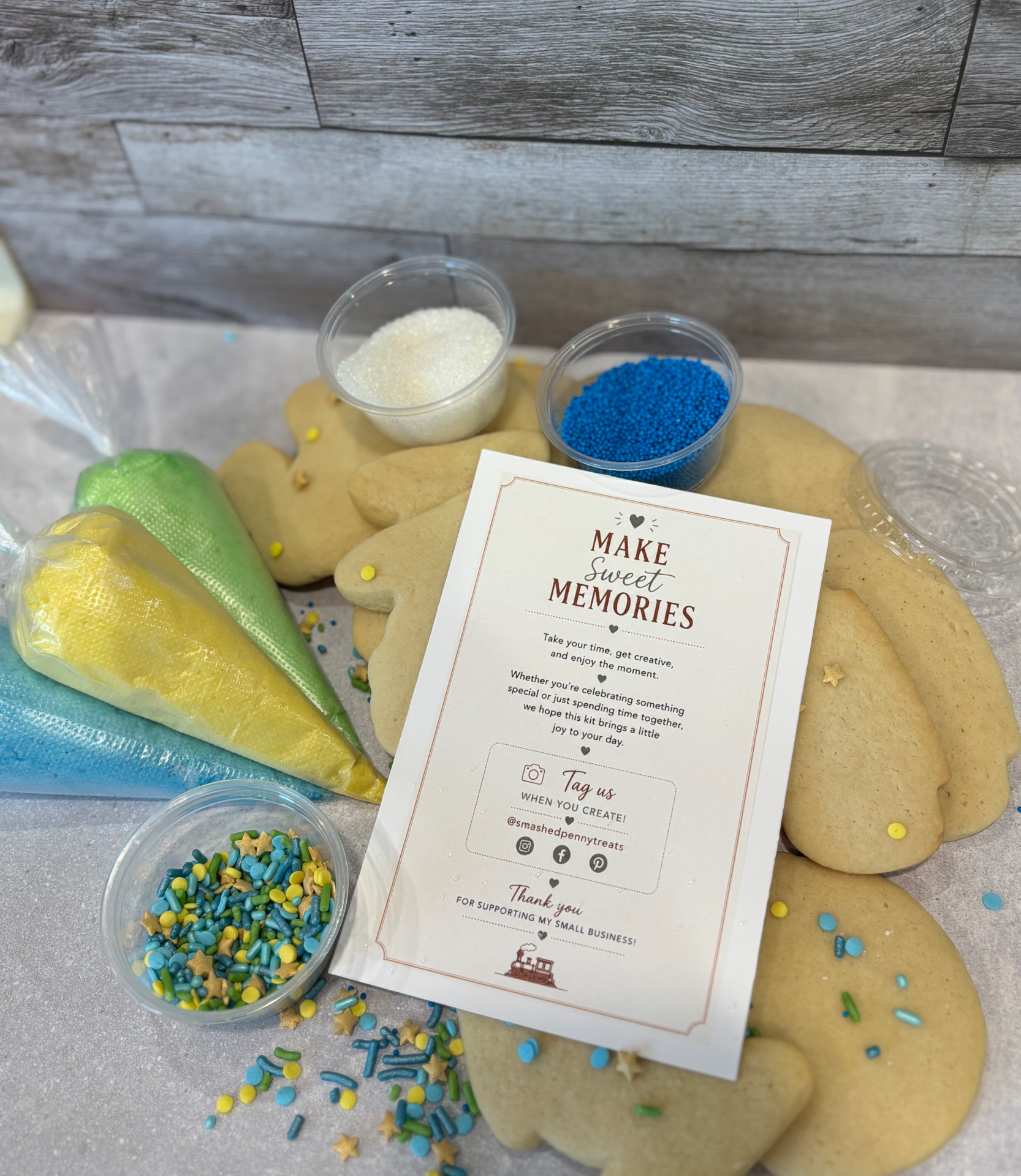 Overhead view of fresh sugar cookies, colorful frosting bags, sprinkles, and a Make Sweet Memories insert card
